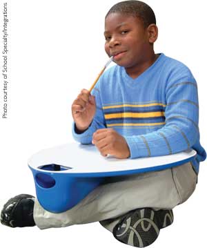Child with lap desk and pencil topper